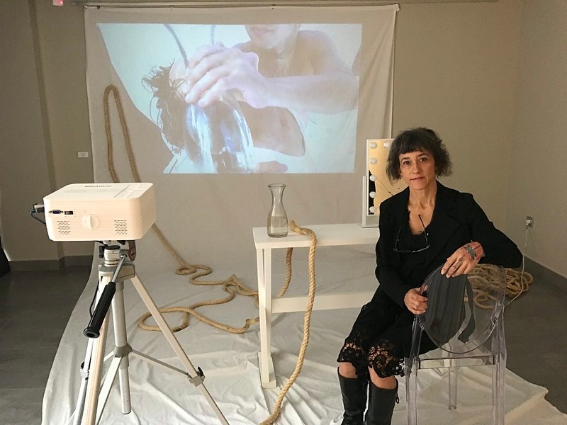Helena Zapke, junto al videoarte creado por Pedro Cartón, que se puede ver junto a las obras de la exposición